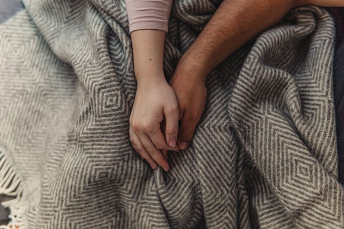 david-dvoracek-WenALu88p7g-unsplash Two people in a relationship holding hands