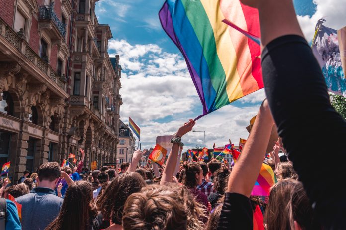 A group of people holding a rainbow flag