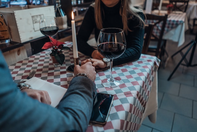 Couple holding hands over dinner