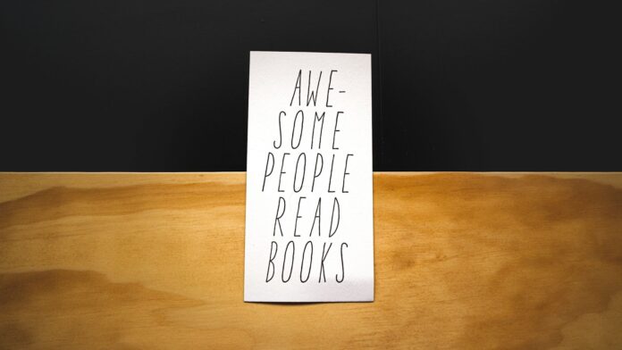 A photo of a paper card saying "Awesome people read books"